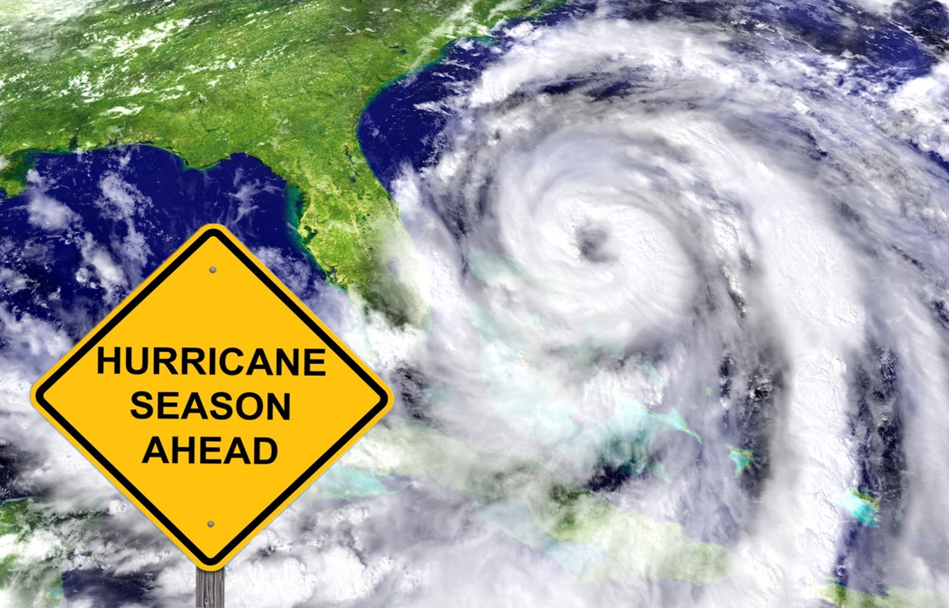 Satellite image of a hurricane cyclone over Florida with a sign that says Hurricane Season Ahead