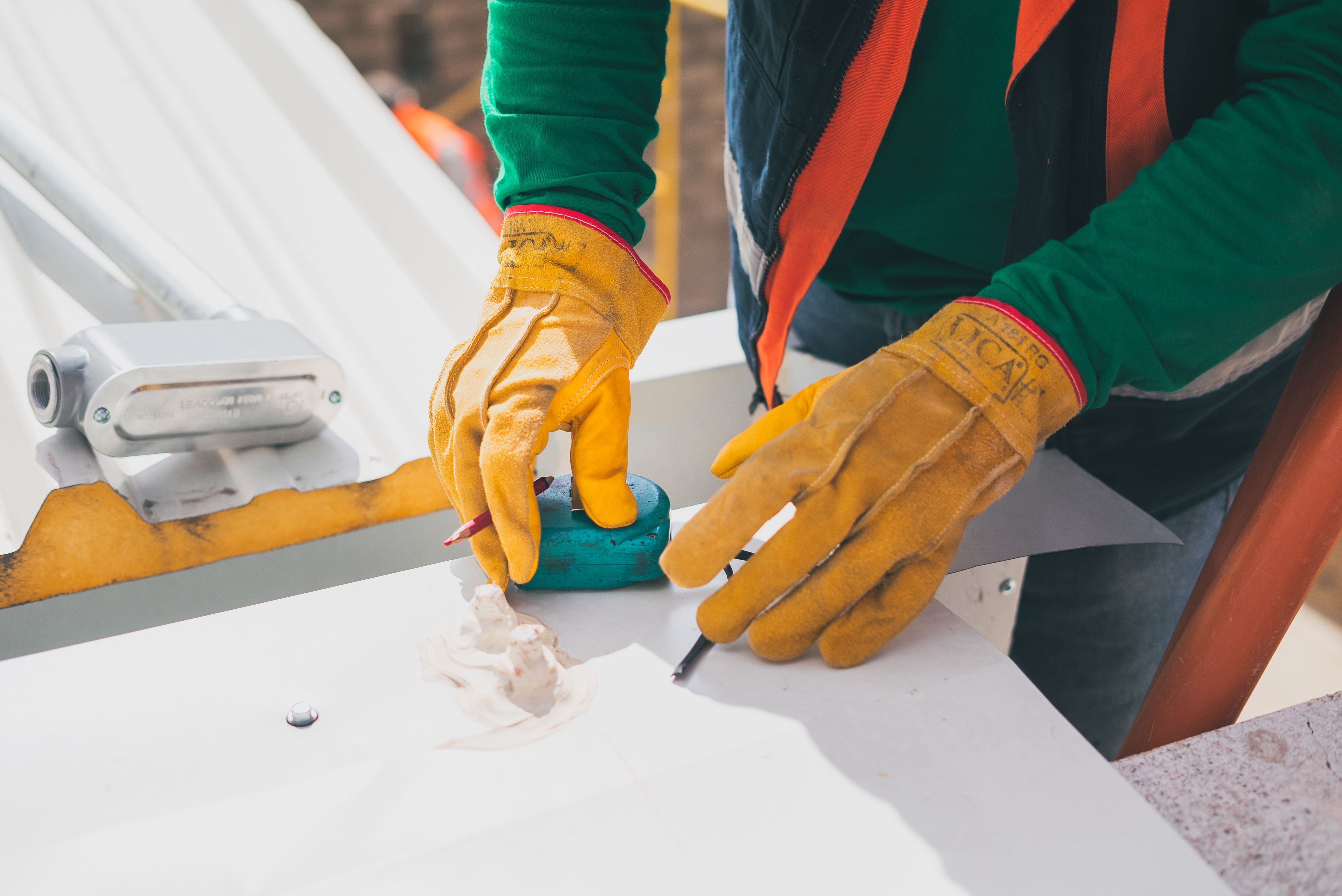 A construction worker preparing to cut material on job site.